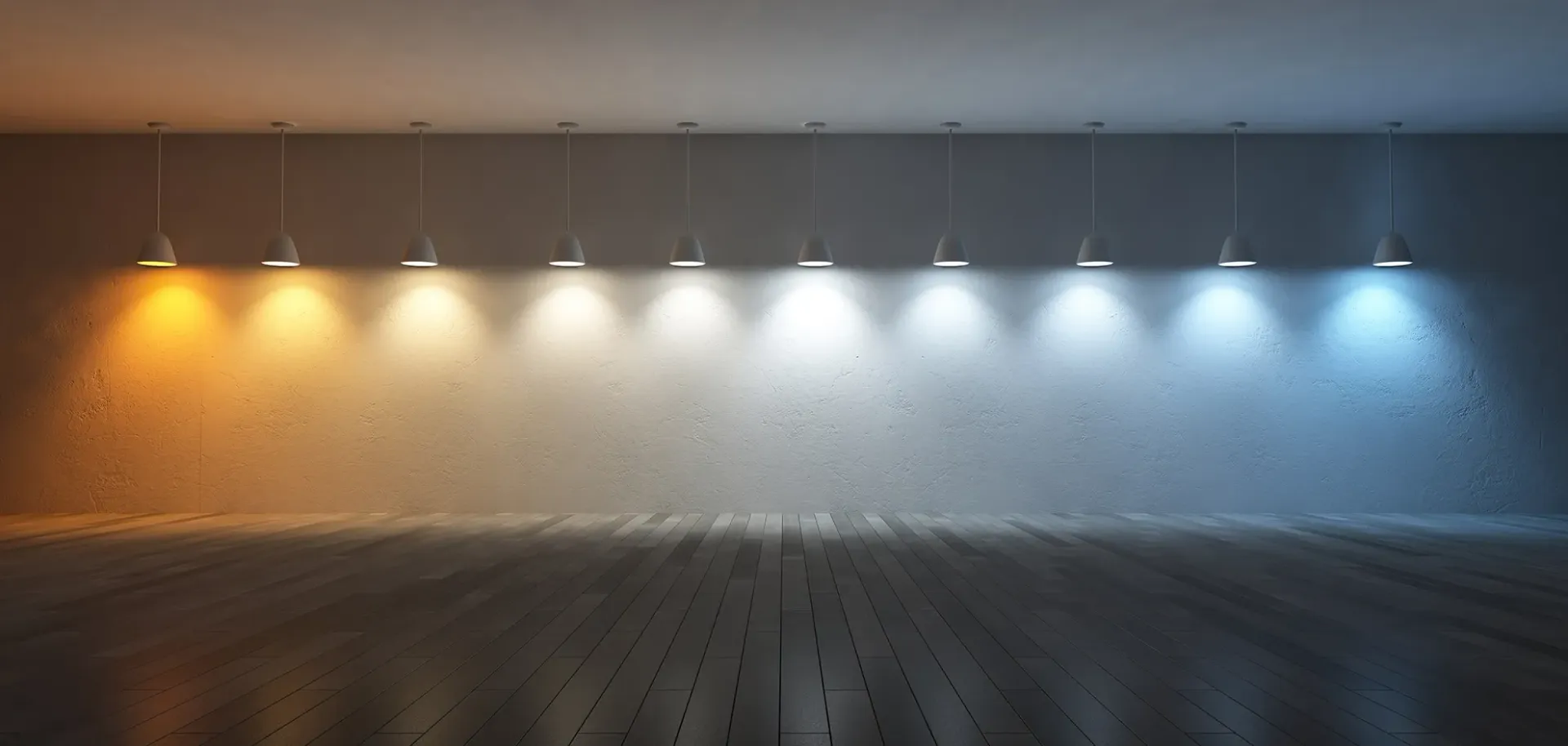A row of pendant lights running from warm to cool colour temperature over a wood floor